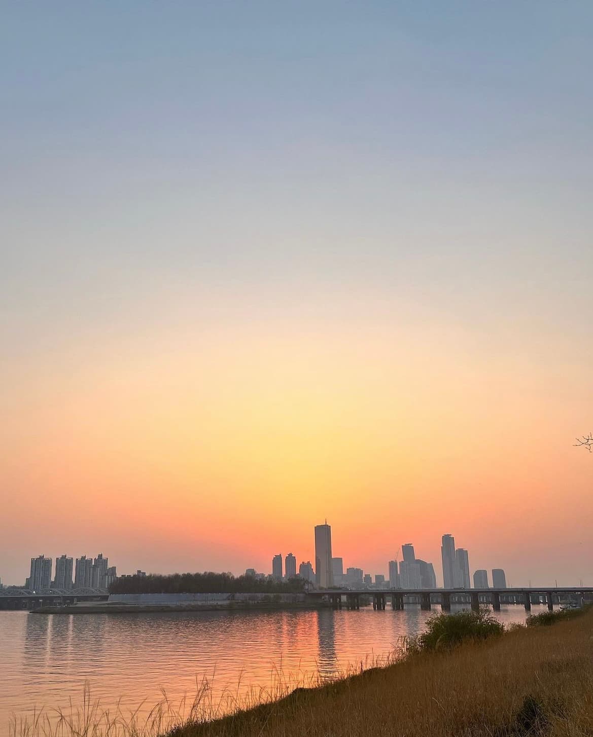 City skyline at sunset over the water
